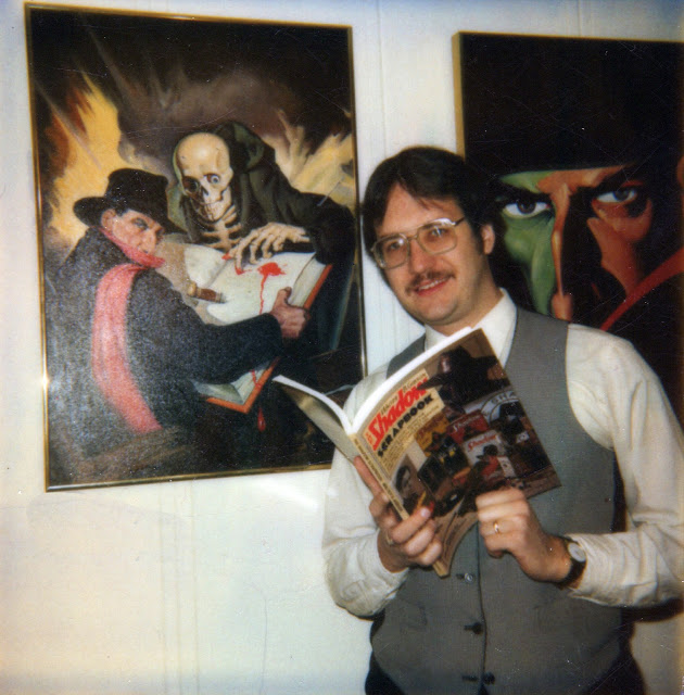 Anthony Tollin holding The Shadow Scrapbook, surrounded by artwork of The Shadow, circa 1994.